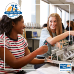 Image of two teenage girls in a classroom engaging in a STEM activity.