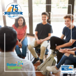 Image of group of diverse teens, sitting in a circle, smiling.